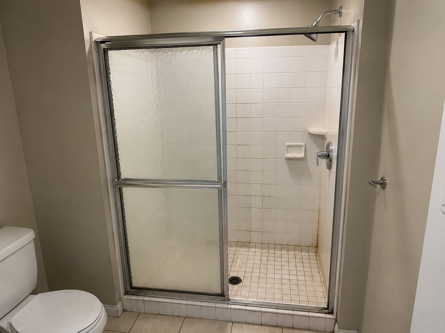 Before: old shower with sliding glass door